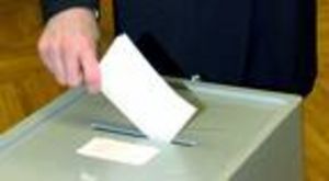 Wähler legt Wahlzettel in den Kasten